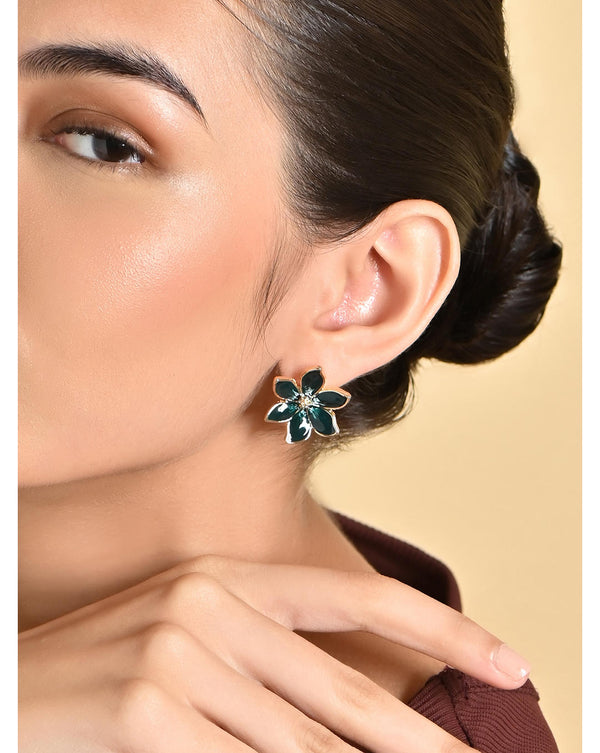 A woman wearing green floral party stud earrings with a gold-plated design, featuring artificial beads.