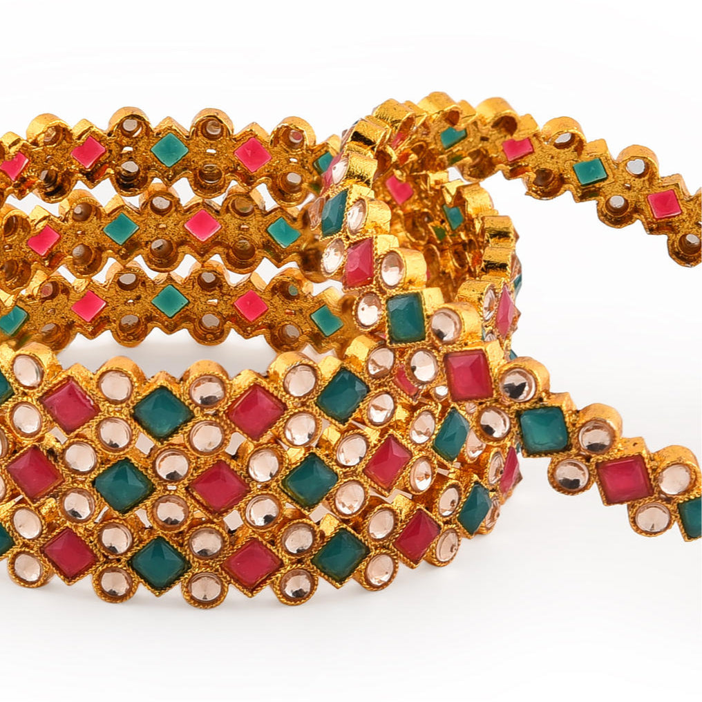 Set of 4 gold-plated geometric bangles studded with ruby red and emerald green stones, traditional Indian jewellery for women, perfect for weddings, parties, and festive ethnic outfits closeup