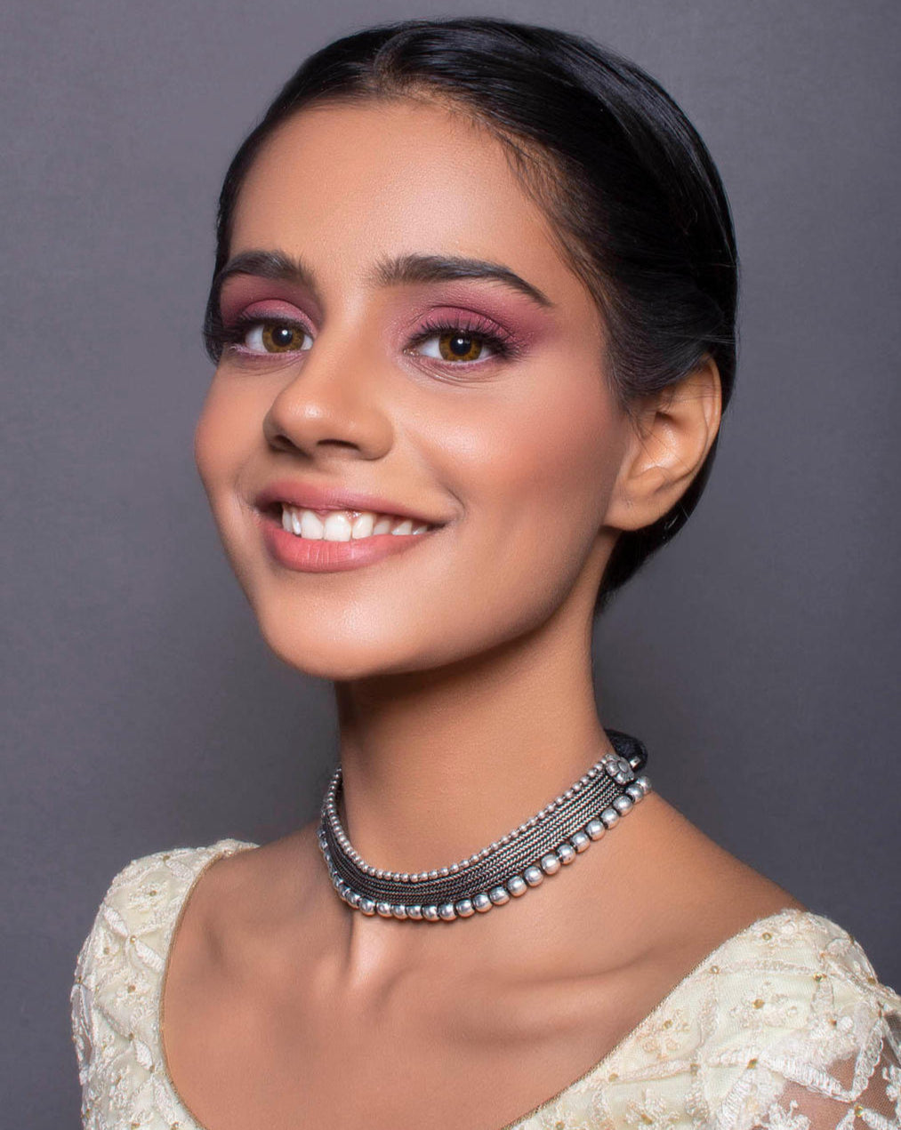 model wearing silver oxidised metal choker necklace with black thread.