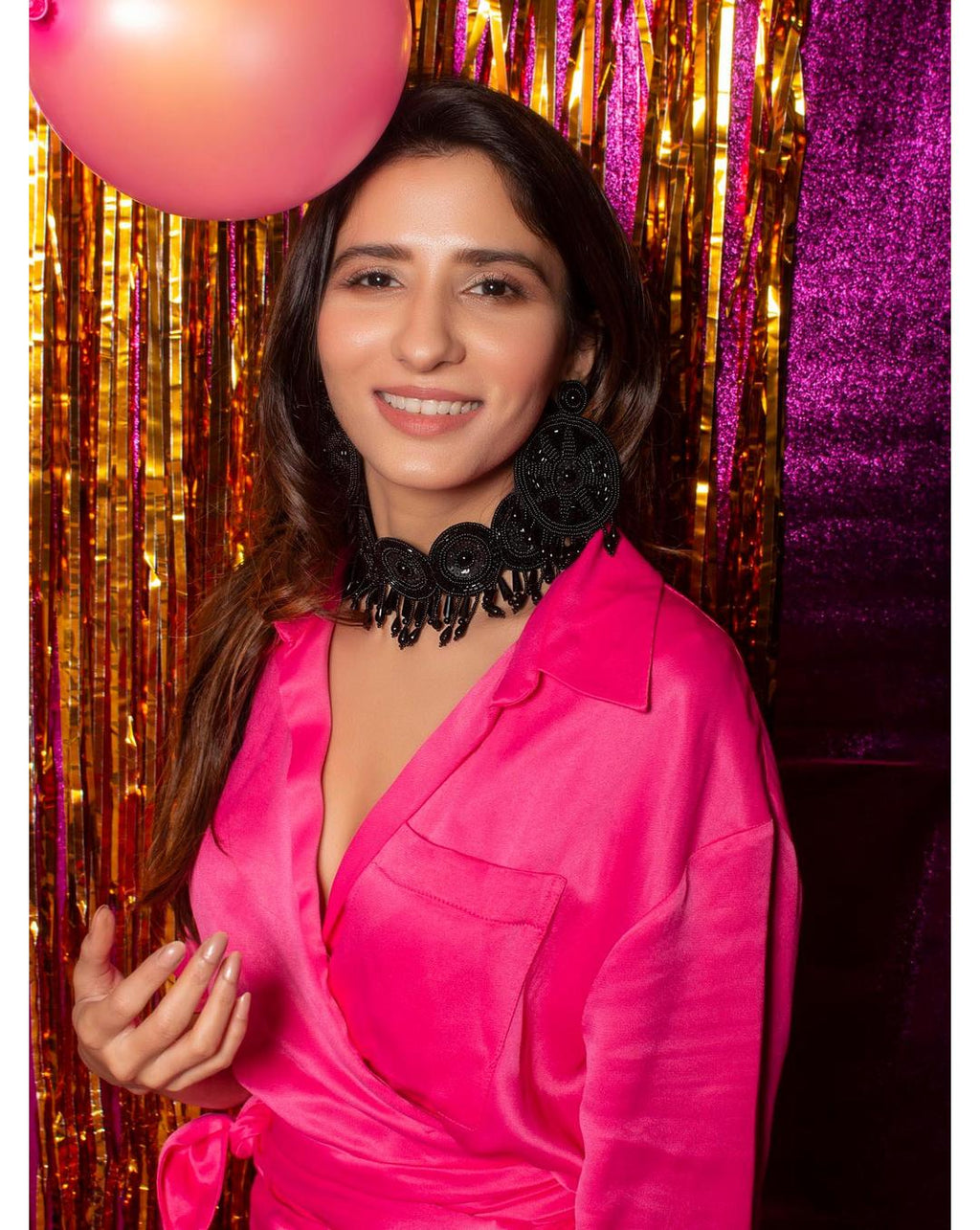 model wearing black seed bead choker necklace with floral motifs and pearl accents in a party