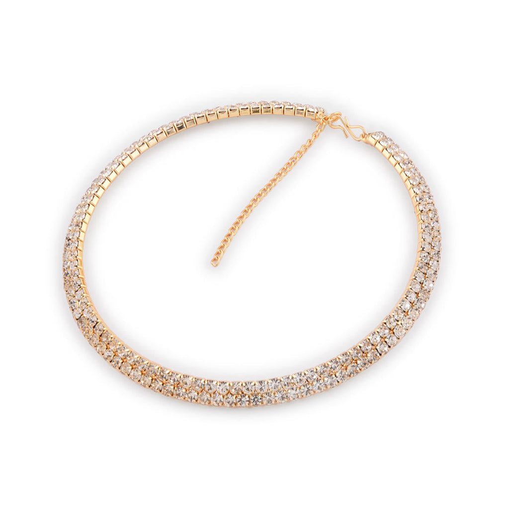 A woman wearing a gold-toned choker necklace adorned with cubic zirconia stones.