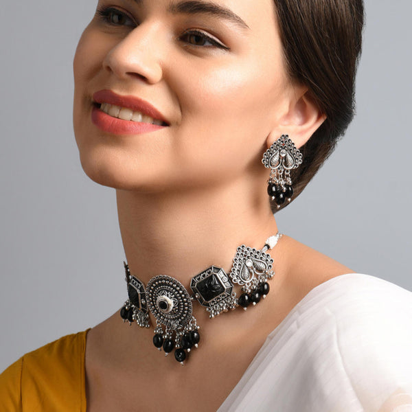 a silver-plated oxidised black beaded peacock jewelry set which includes a necklace and a pair of earrings.