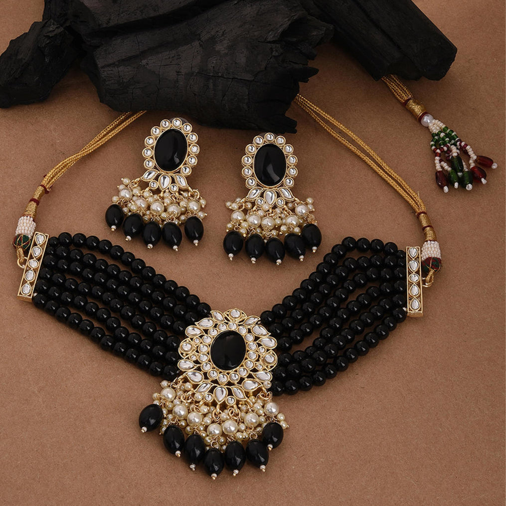 black and gold colored kundan pearl choker necklace and matching earrings.
