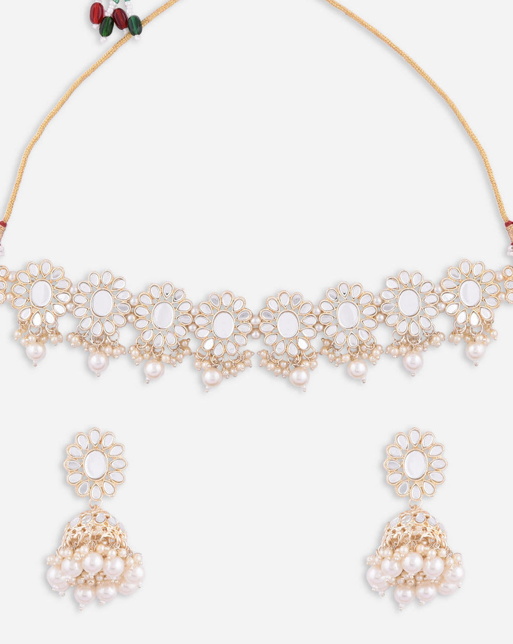 a traditional pearl and mirror kundan jewellery set which includes a choker necklace, earrings, and a maang tikka. The set is gold-plated with white artificial stones closeup