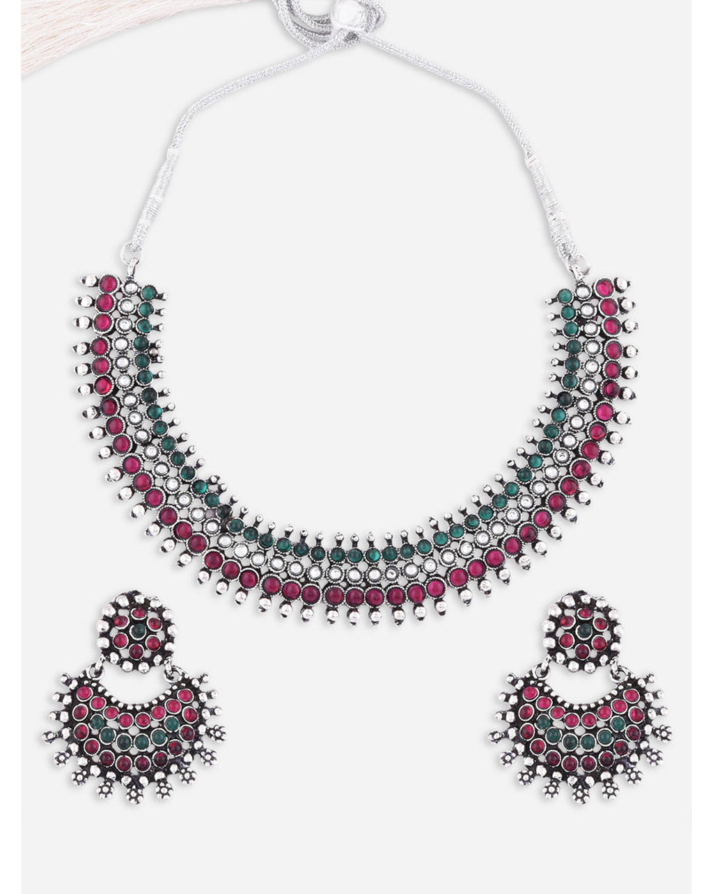 A South Indian traditional silver choker necklace and earrings set with marron and kundan embellishments.