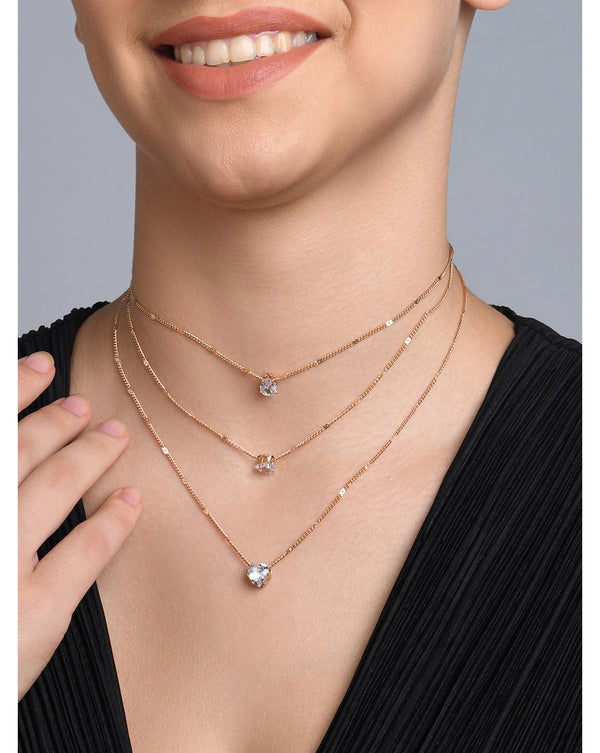A gold-plated three-layered necklace with celestial symbols such as a heart, a star, and a moon, adorned with sparkling CZ stones