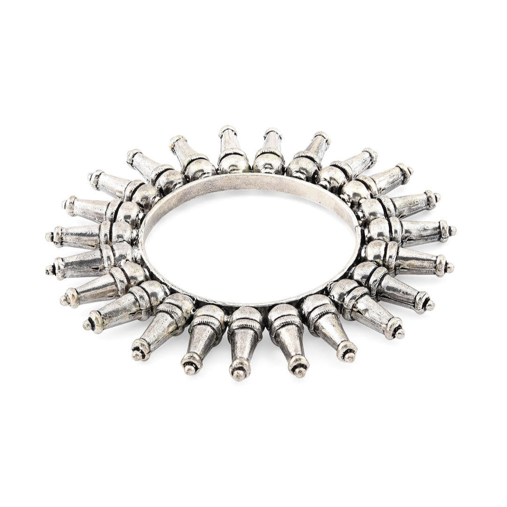 A silver-plated oxidized tribal kada bangle with a rays pattern