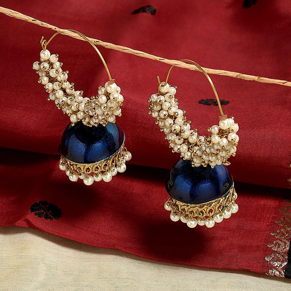 A pair of navy blue and gold sculpted hoop earrings with pearl accents, displayed against a red fabric background. #1 Best Seller