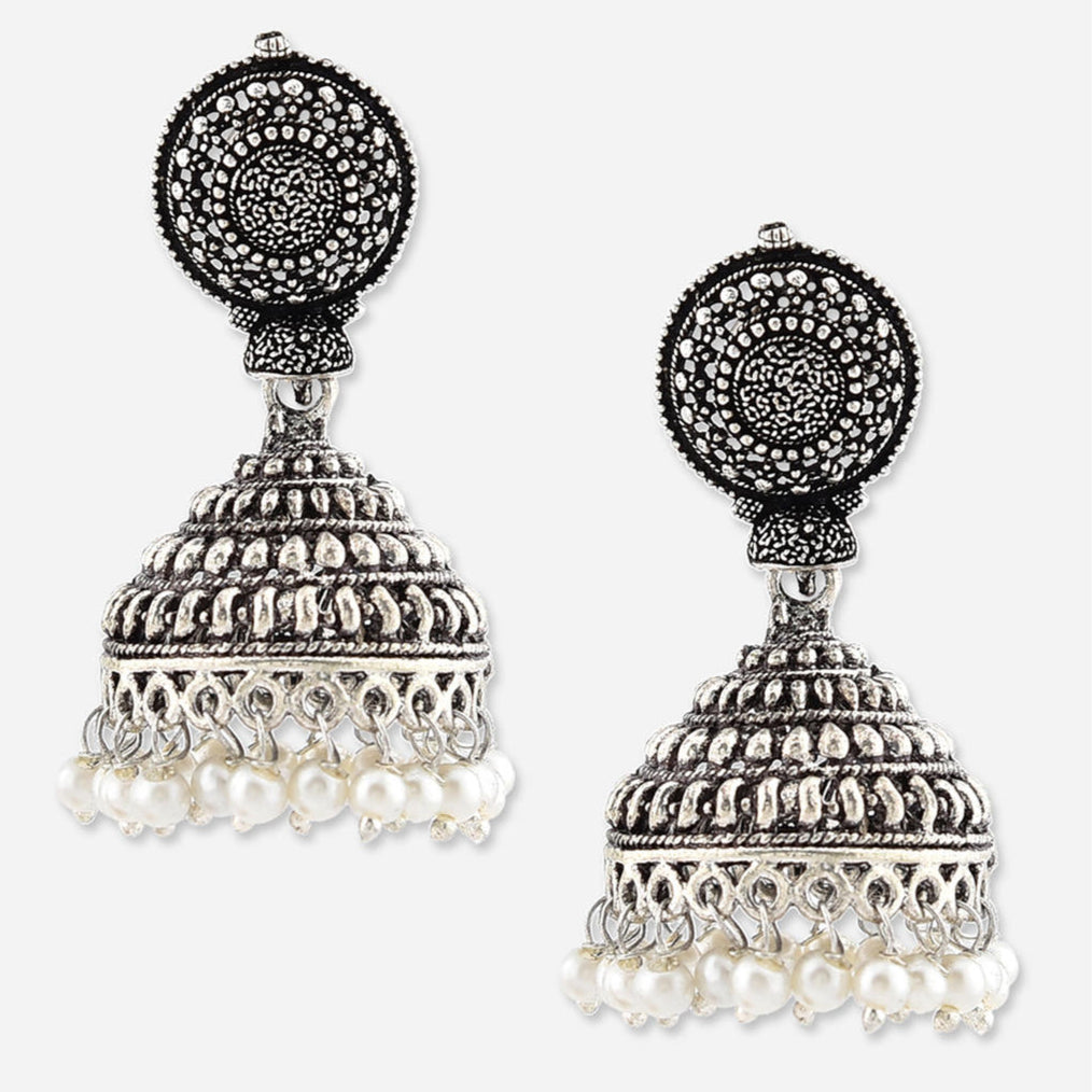 Two silver-plated oxidised jhumka earrings with intricate designs and small pearl embellishments