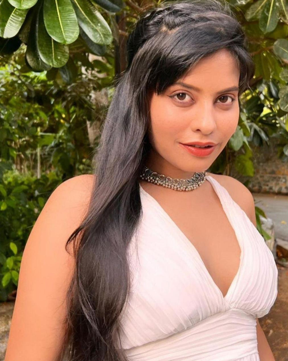 model wearing a silver oxidized choker necklace with mirrored ghungroo details.