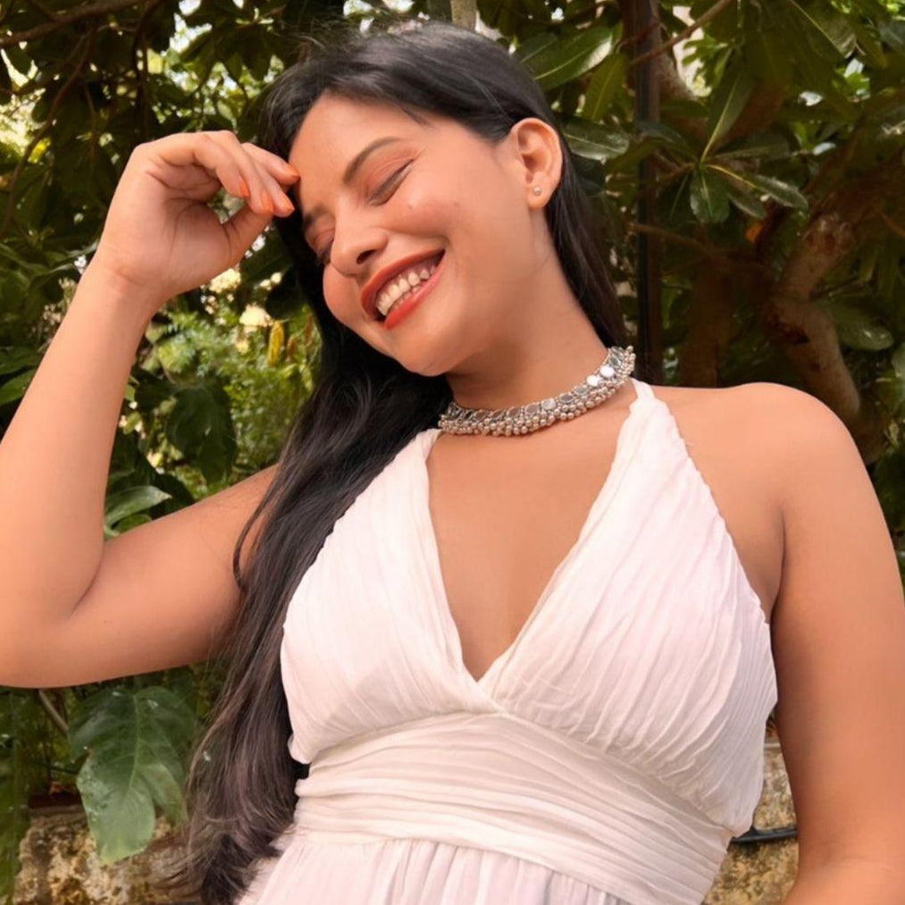 women wearing a silver oxidized choker necklace with mirrored ghungroo details.
