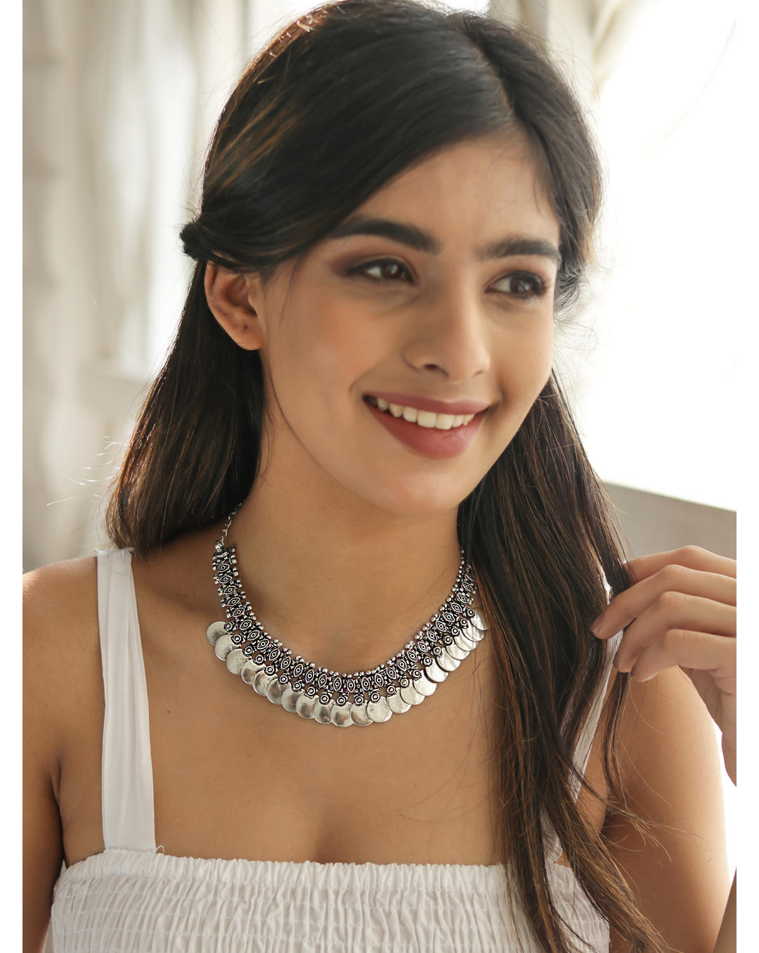 Model wearing A silver-coloured vintage coin choker necklace.