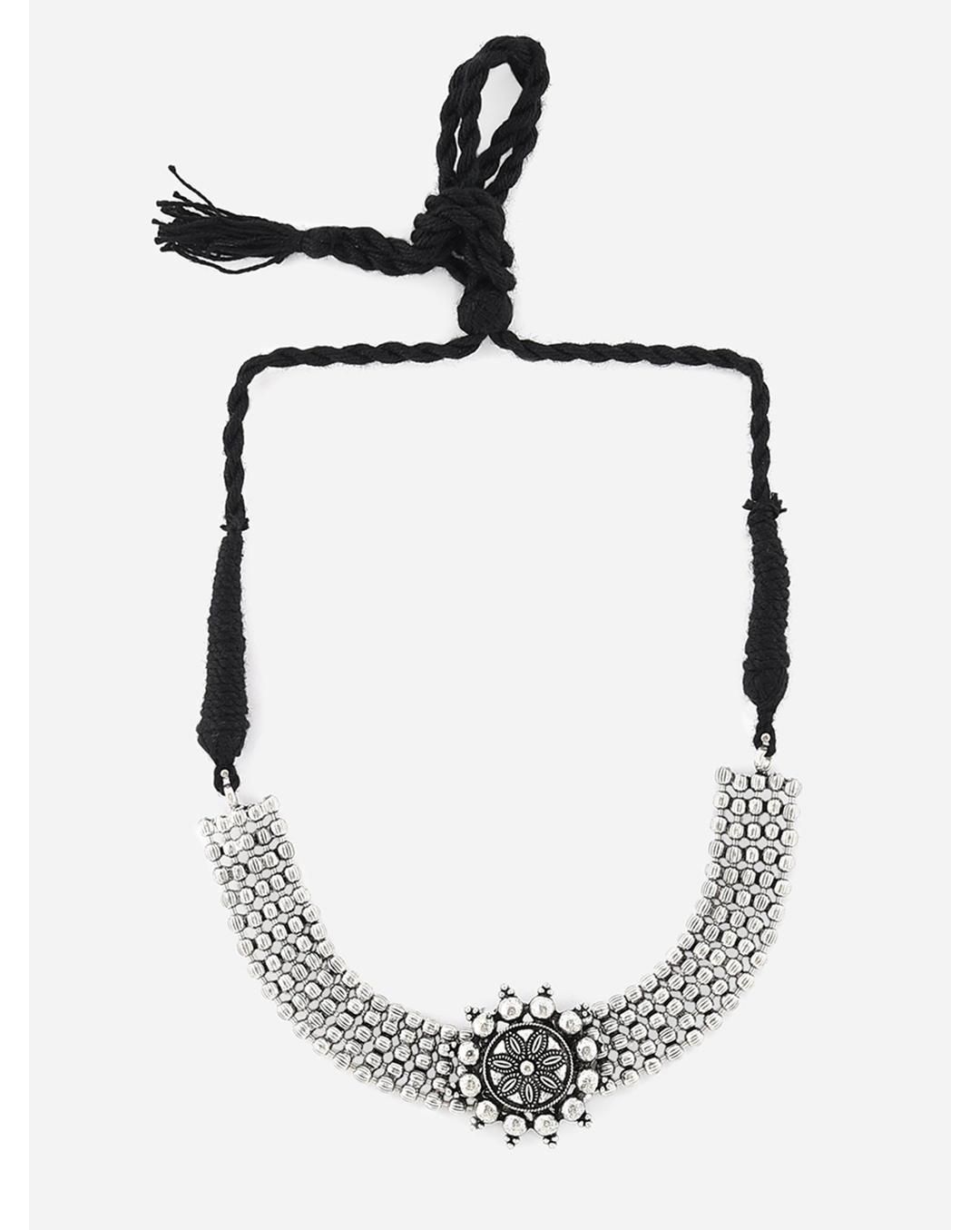 A silver oxidised choker necklace with a circular mandala-inspired pendant at the center, suspended from a black thread chain on a white background