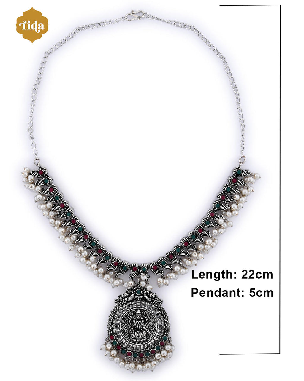 A silver-plated oxidised temple jewellery set with white pearls and green and red stones, featuring a detailed pendant and a pair of earrings. dimension