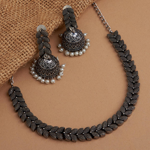 Oxidized silver-plated necklace with textured leaf motifs and matching jhumka earrings featuring pearl bead detailing – ethnic jewellery set
