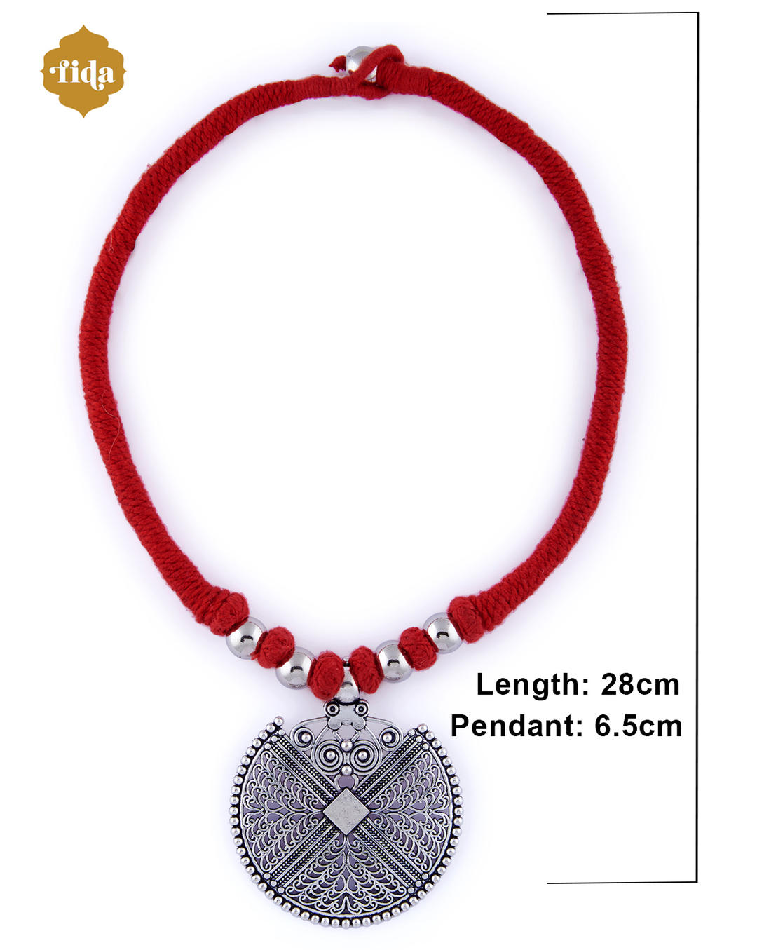An oxidised mandala pendant necklace with intricate detailing, attached to a red thread with silver beads on white background with dimension