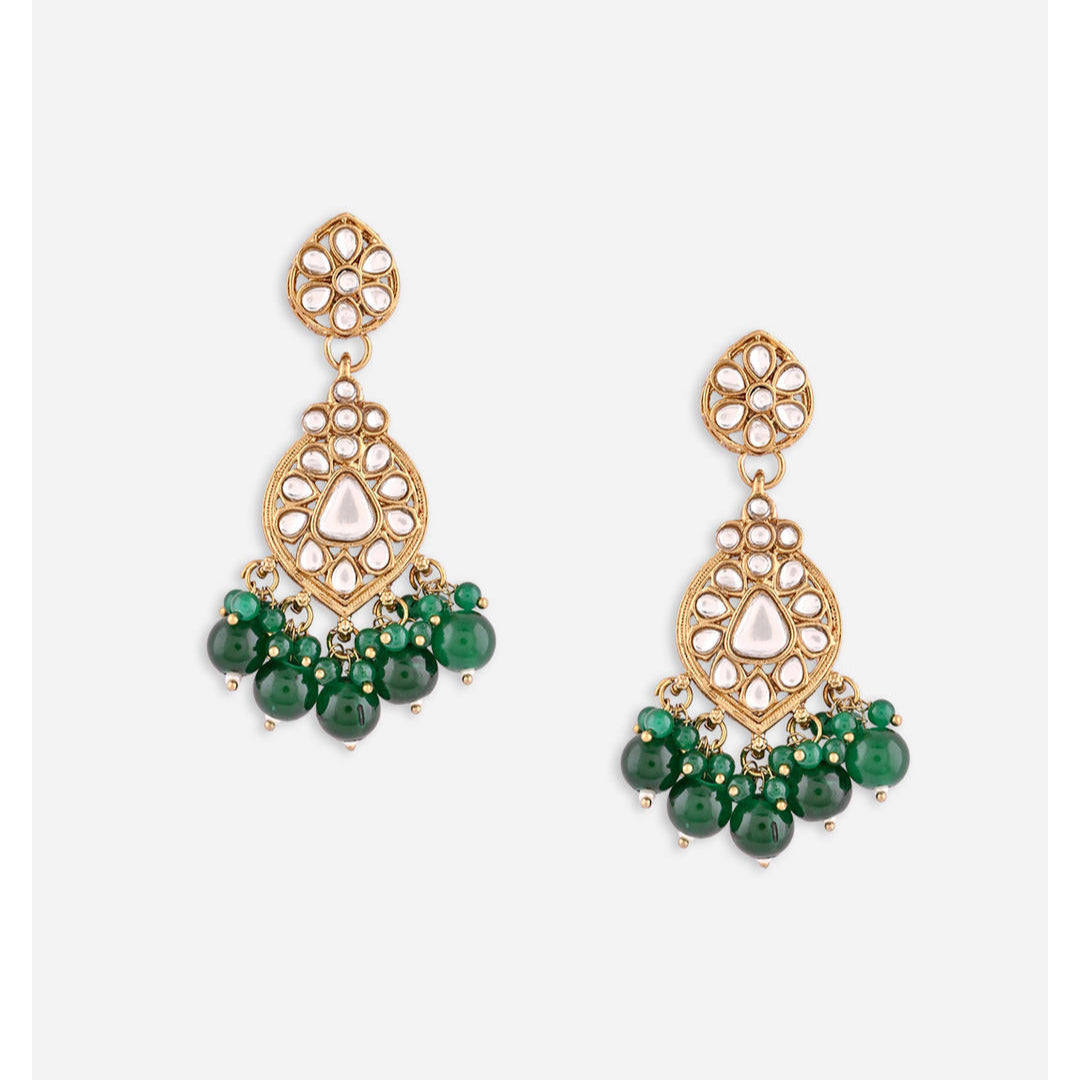 A pair of golden drop earrings with kundan stones and green beads