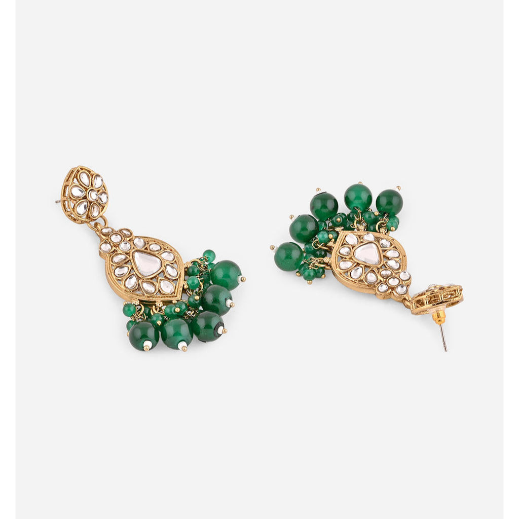 A pair of golden drop earrings with kundan stones and green beads