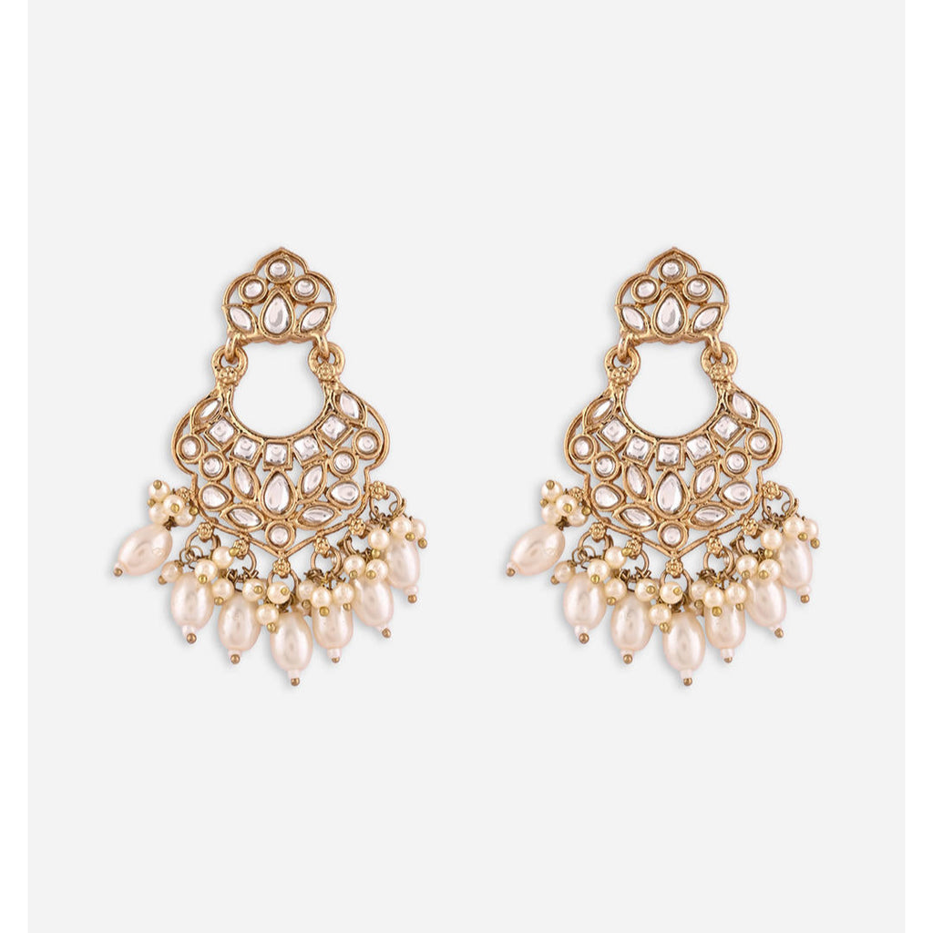 A pair of gold-plated white kundan pearl chandbali earrings with intricate designs and drop-shaped pearls.