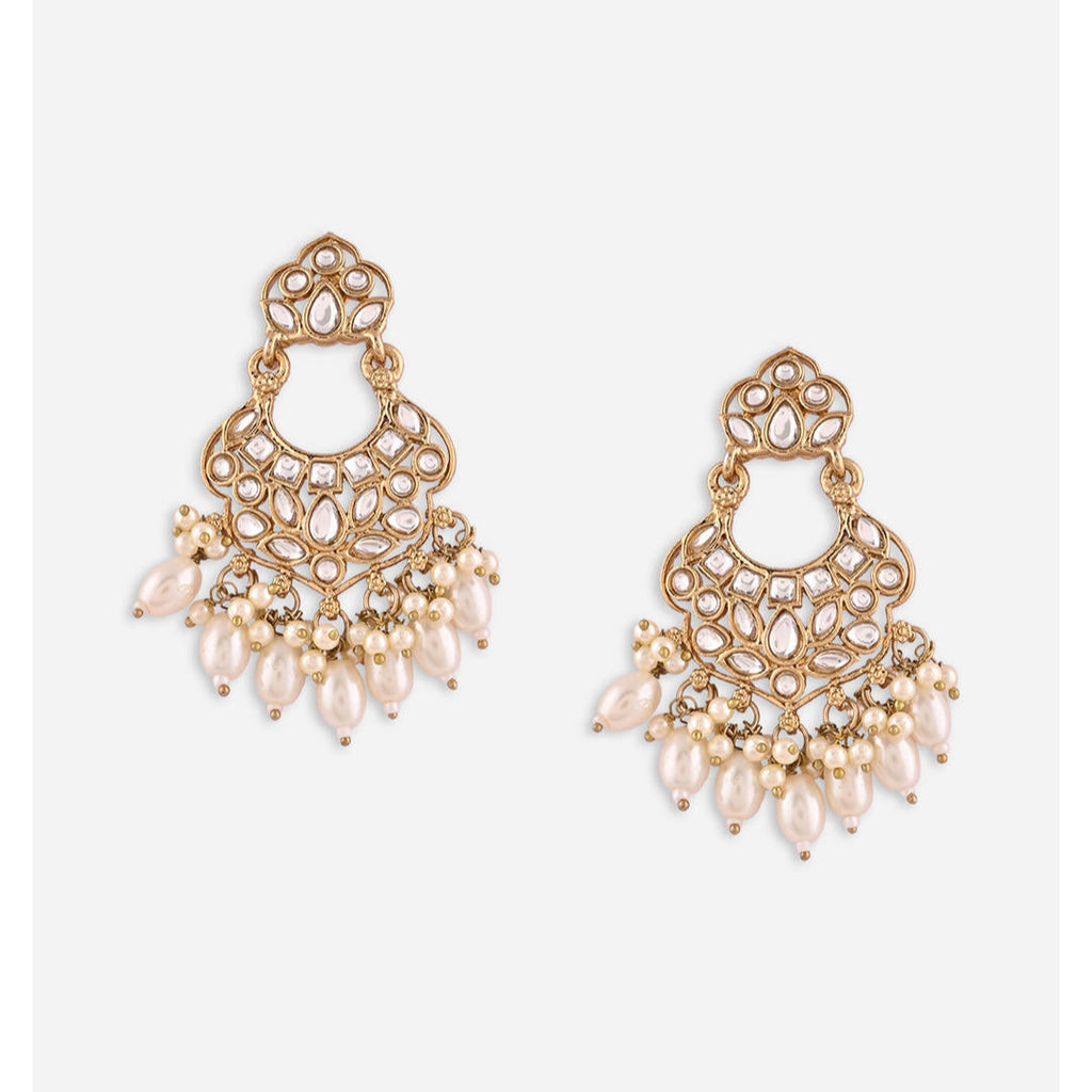 A pair of gold-plated chandbali earrings adorned with white kundan stones and pearl drops