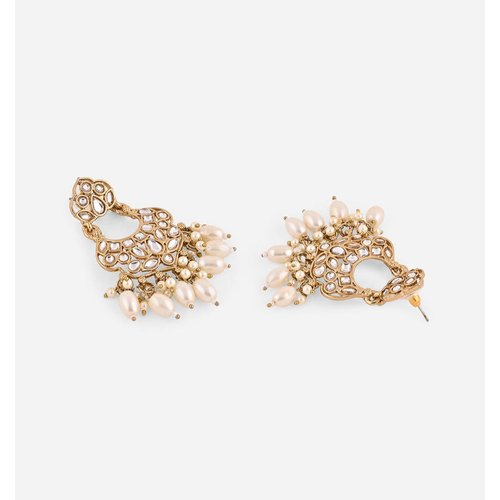 A pair of gold-plated chandbali earrings adorned with white kundan stones and pearl drops