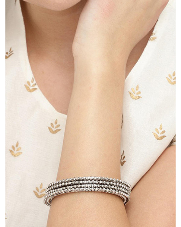 Set of 4 silver-plated textured bangles with intricate detailing, elegant ethnic jewellery for women, perfect for weddings, parties, and traditional Indian outfits