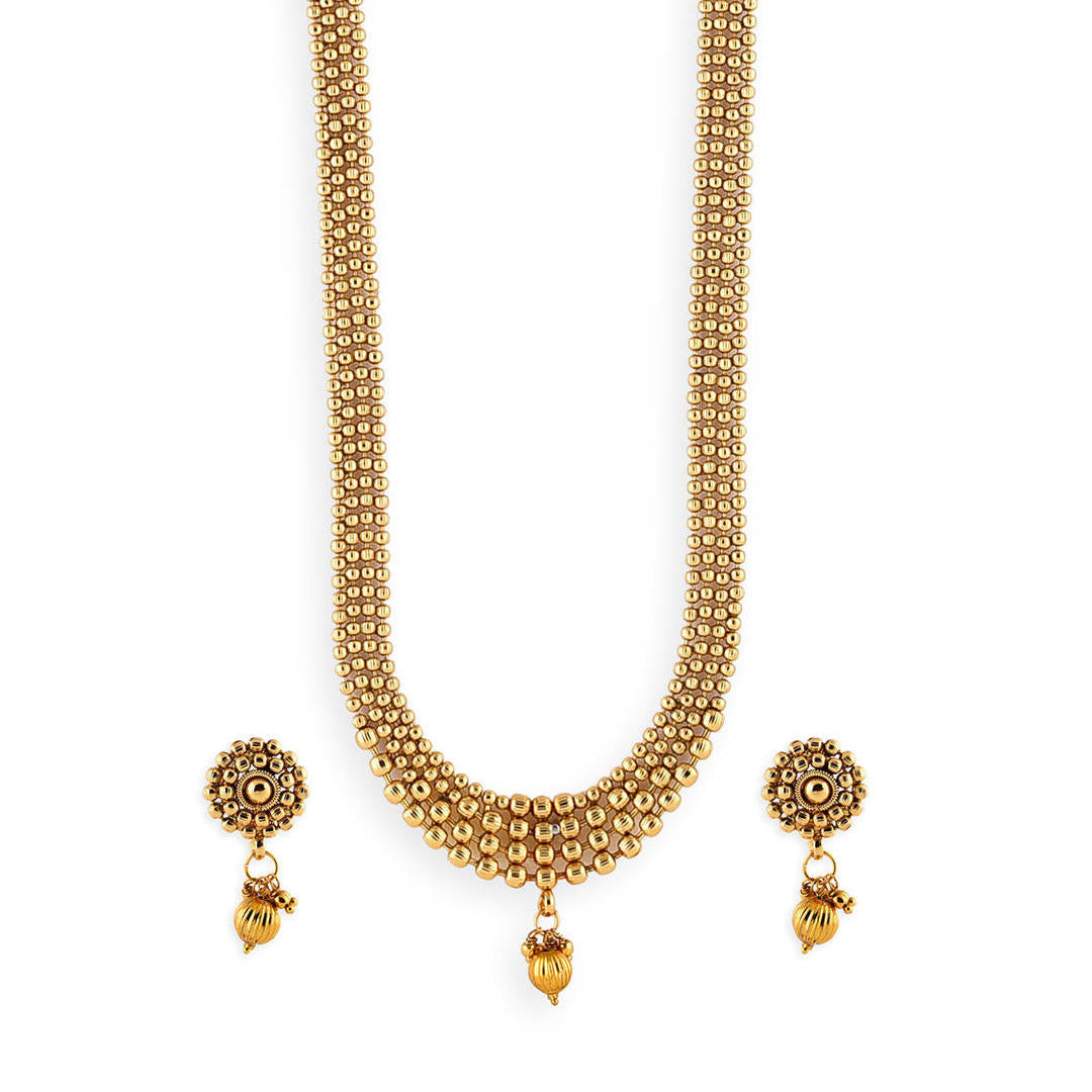old-plated metal beaded statement jewellery set, including earrings and a necklace close-up