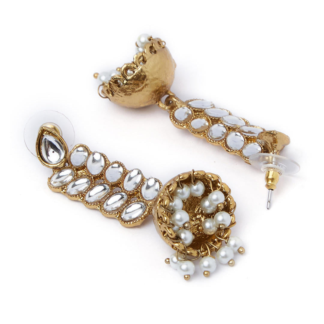 Gold plated jhumka earrings with kundan stone embellishments and a leaf design