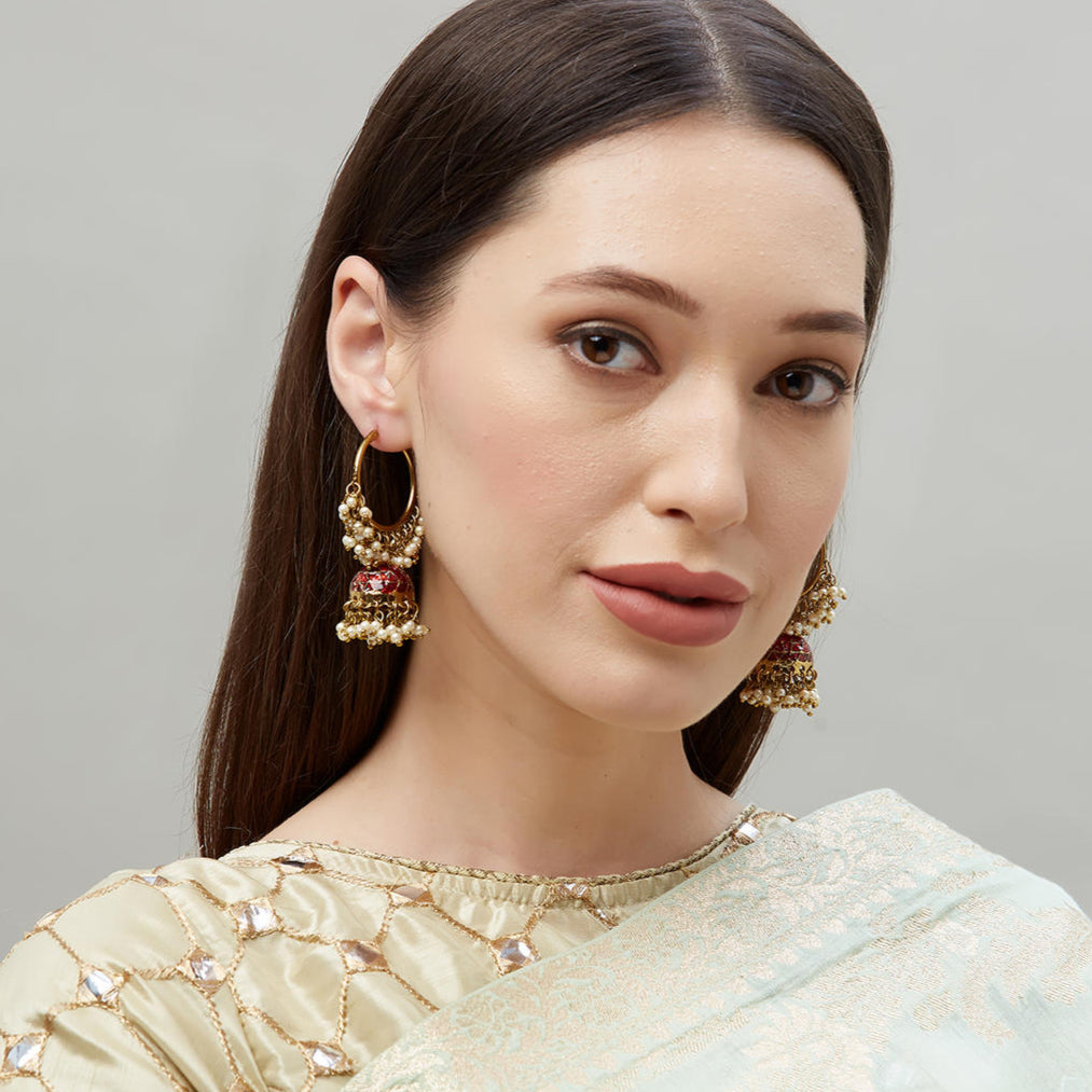 A pair of gold-plated hoop jhumka earrings with red enamel and white beads embellishments