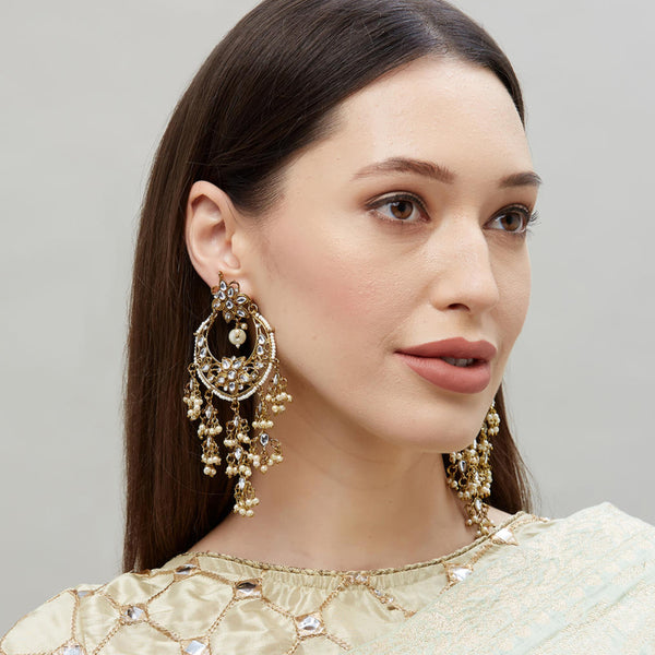 a gold-plated chandbali earring embellished with kundan beads and pearls.