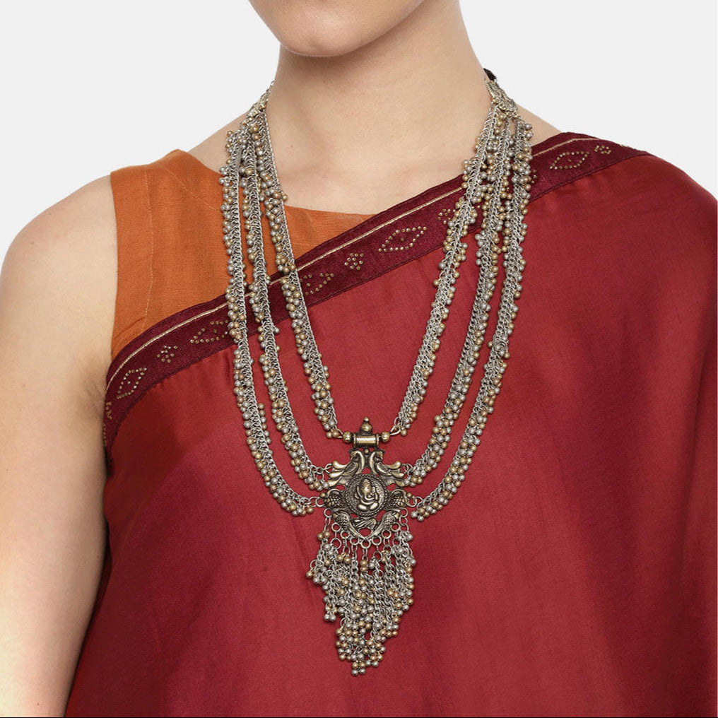 women wearing multistrand long necklace with a Ganesh pendant
