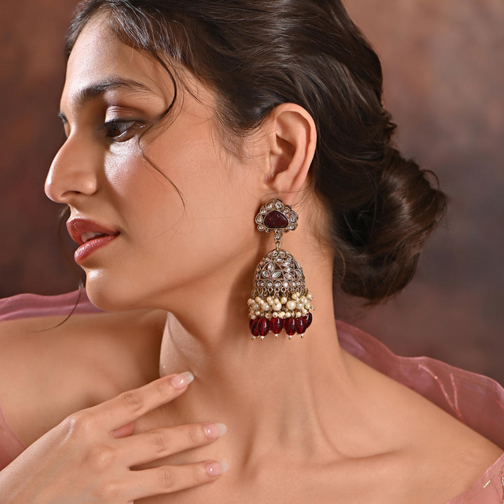 merlot burgundy jhumka earrings with kundan stones, beige pearls, and maroon beads.