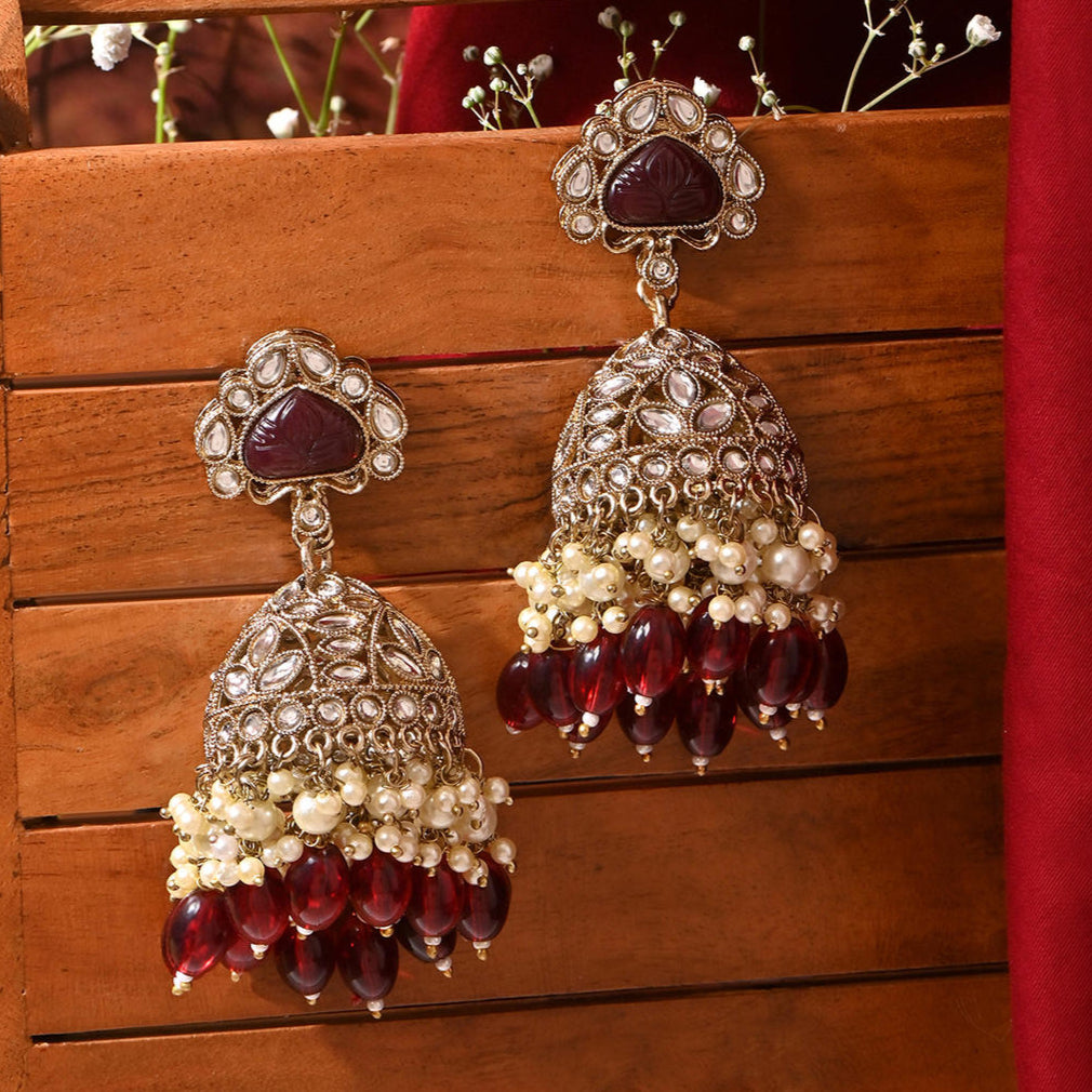 merlot burgundy jhumka earrings with kundan stones, beige pearls, and maroon beads.