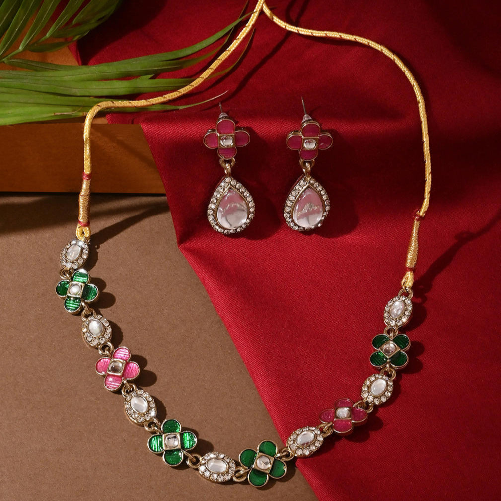 a multicolored traditional jewelry set which includes a floral design necklace and matching earrings.