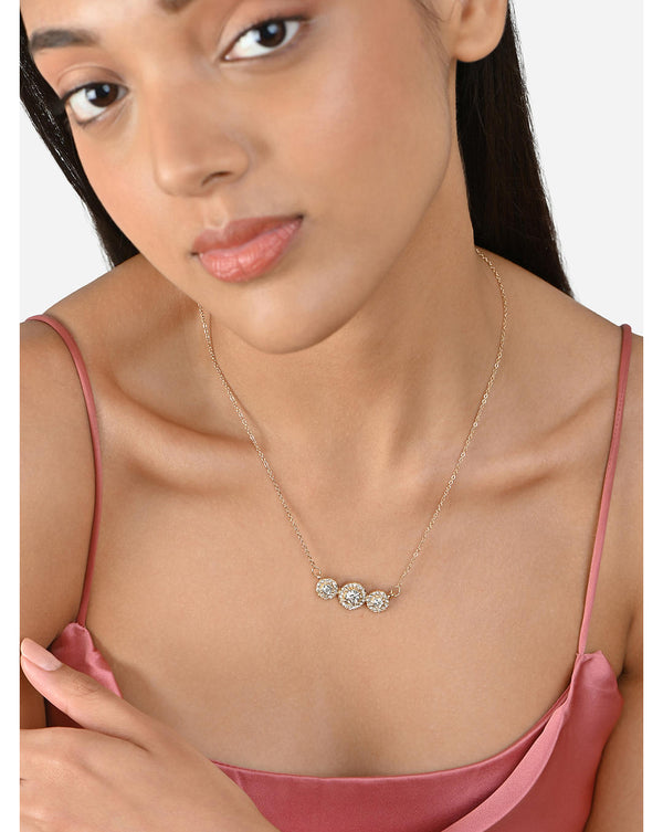 A gold-plated metal pendant necklace with three gemstone accents arranged in a straight line
