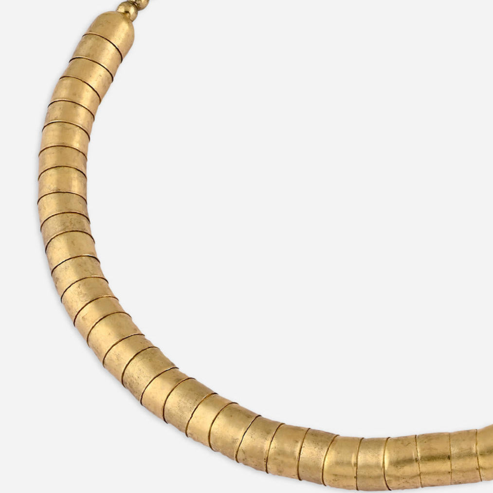 gold-toned choker necklace with a curved rod design covered in fused beads.