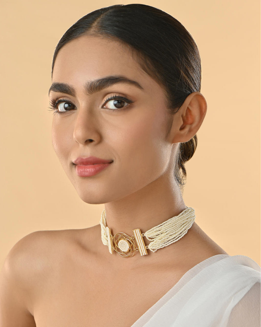 model wearing A floral pearl filament choker necklace with gold-toned settings and white pearl floral motifs