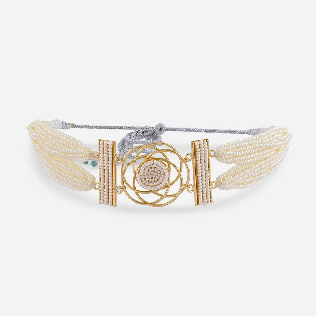A floral pearl filament choker necklace with gold-toned settings and white pearl floral motifs close-up