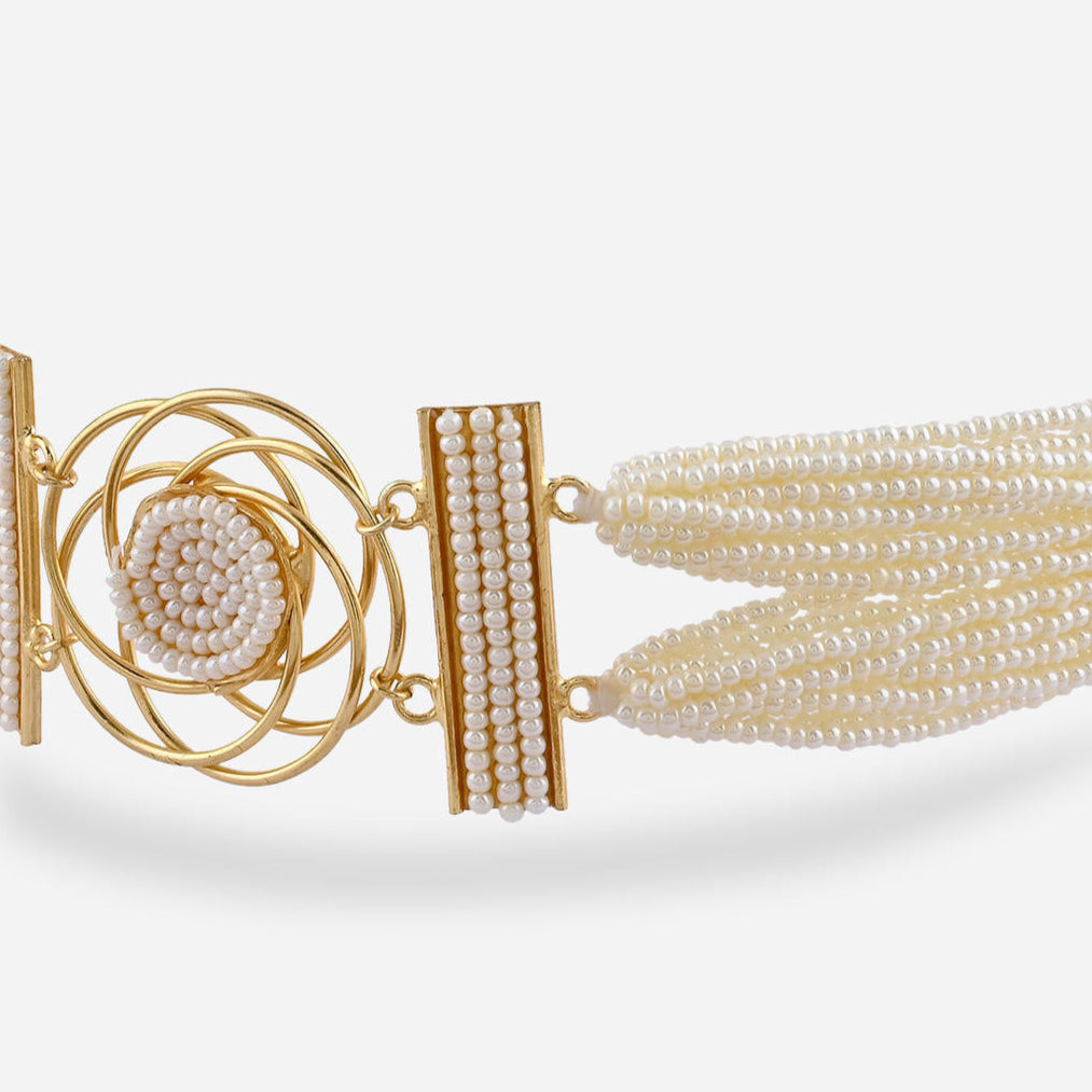 A floral pearl filament choker necklace with gold-toned settings and white pearl floral motifs close-up