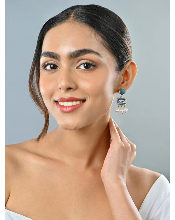 Pair of earrings with blue gemstones, gold accents, and pearl beads