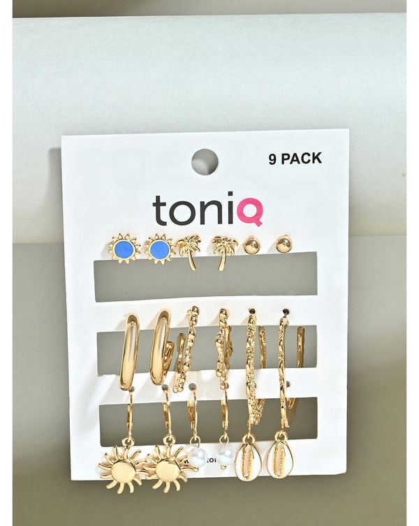 A pack of nine gold-tone earrings displayed on a card, featuring various designs including florals, trees, sun motifs, multicolor studs, hoops, and pearls.
