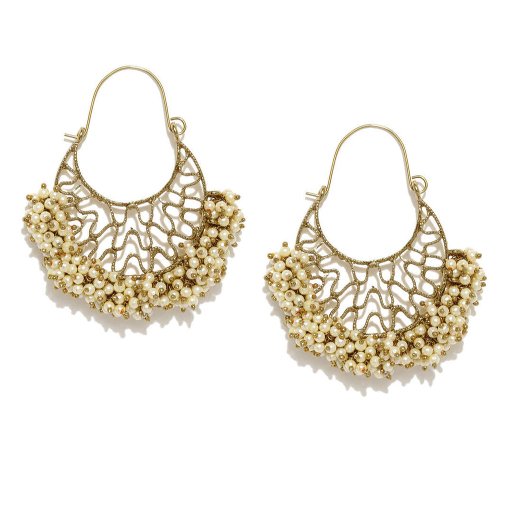 A pair of gold-plated chandbali earrings with white beads arranged in a crescent pattern