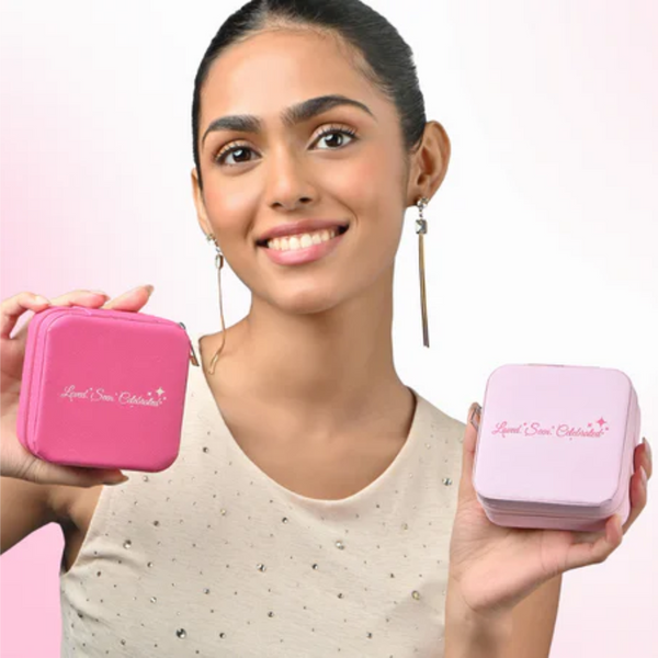 Woman holding toniq's two pink jewelry boxes with a brand logo on a white background
