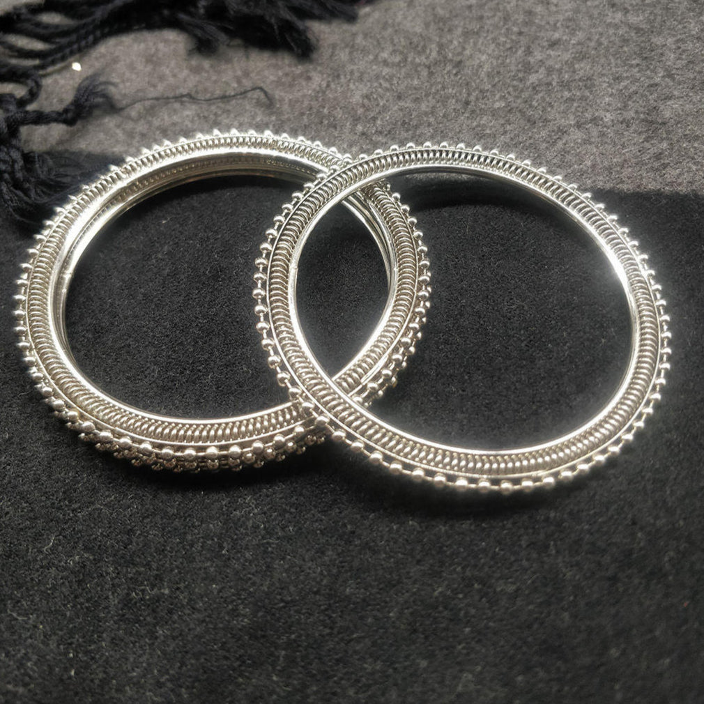 Set of 4 silver-plated textured bangles with intricate detailing, elegant ethnic jewellery for women, perfect for weddings, parties, and traditional Indian outfits