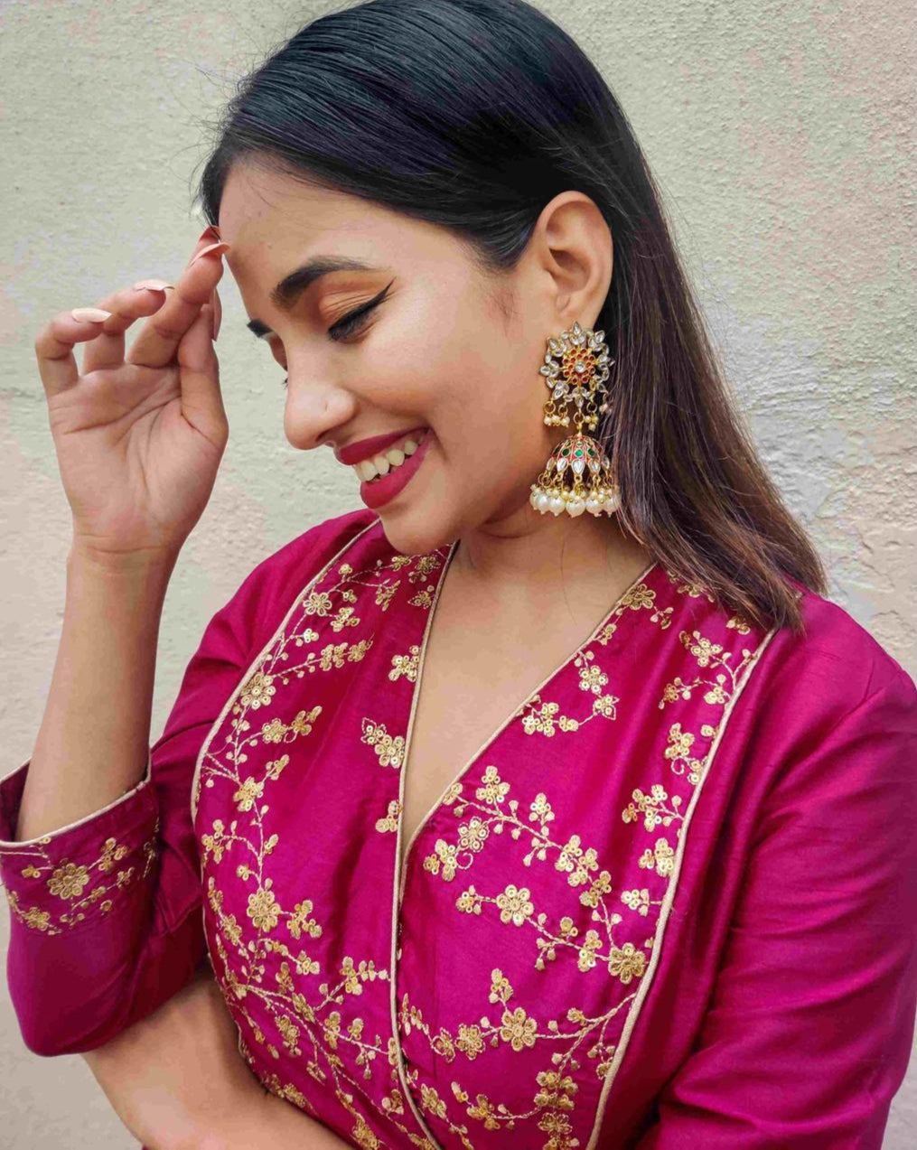 Gold plated enameled jhumka earrings with maroon kundan stones and pearl embellishments